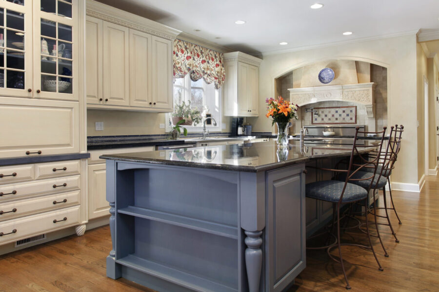 Upscale kitchen with a gray cabinet granite island